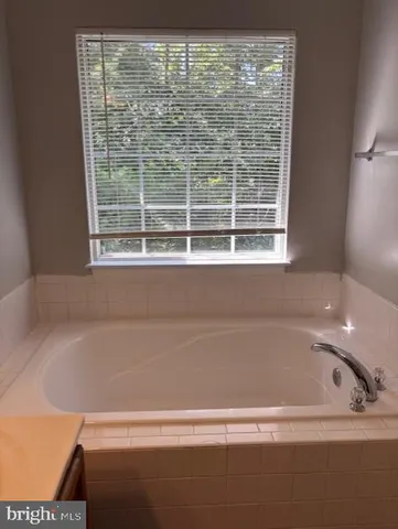 a white toilet sitting next to a shower