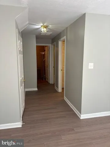 an empty room with wooden floor and closet