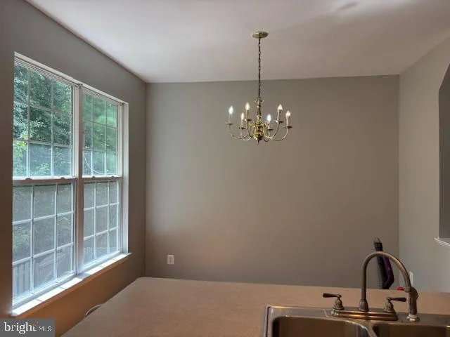 a kitchen with granite countertop a sink and a stove top oven