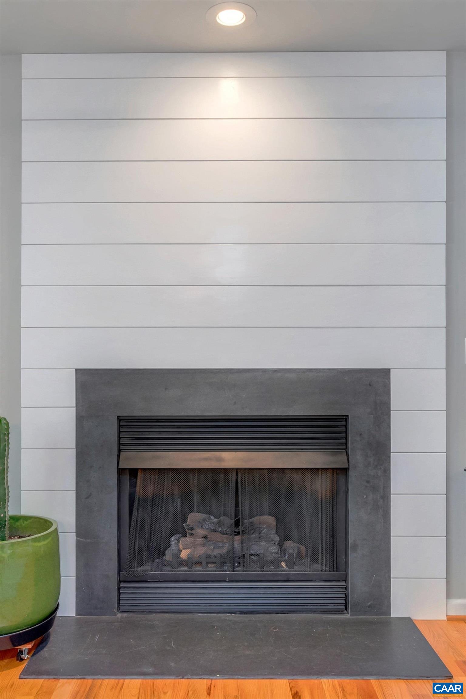 27 East Point Road Palmyra, VA 22963 - Photo 29 of 62 a fireplace with a clock on wall
