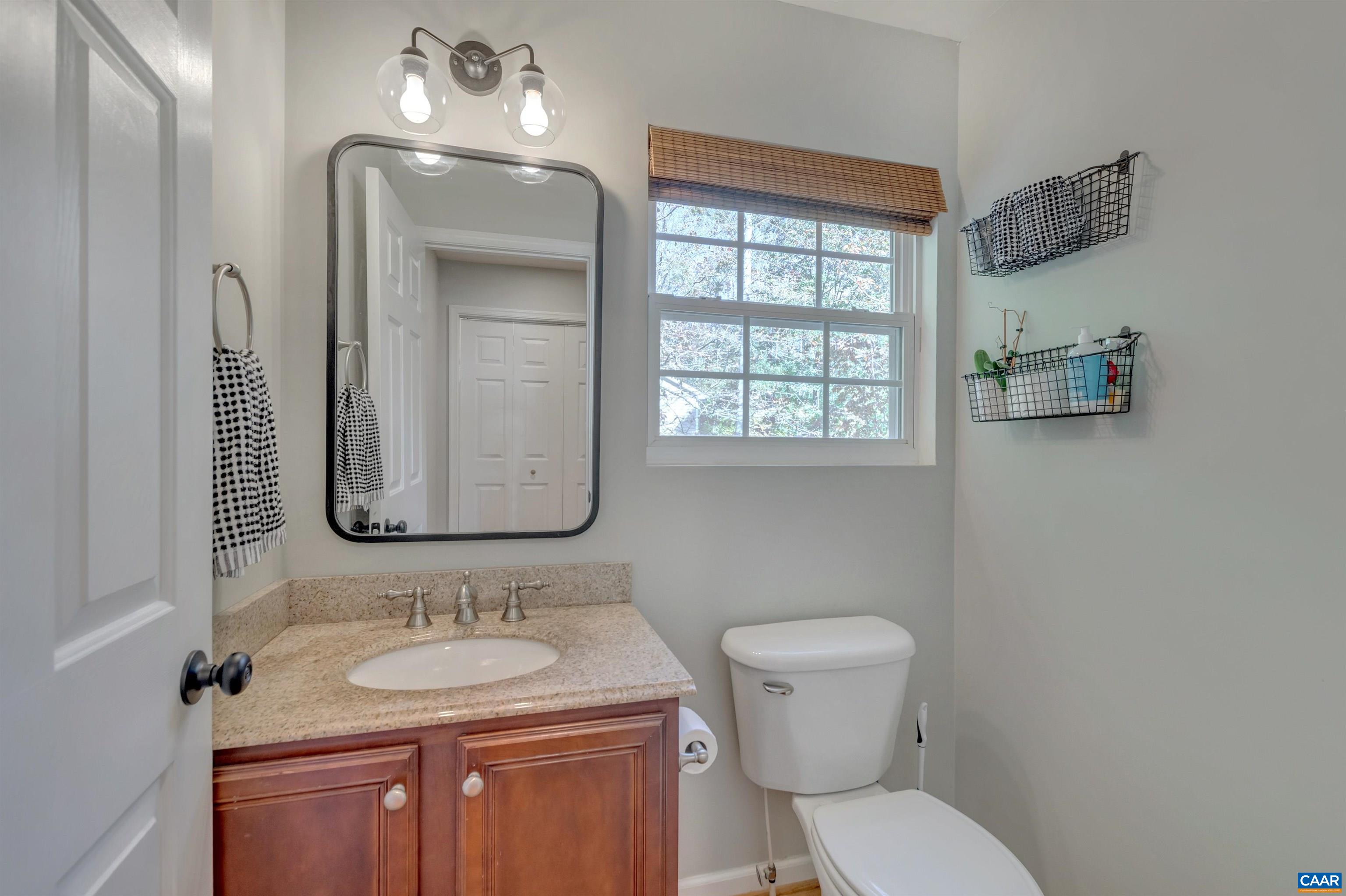 27 East Point Road Palmyra, VA 22963 - Photo 31 of 62 a bathroom with a toilet sink and mirror