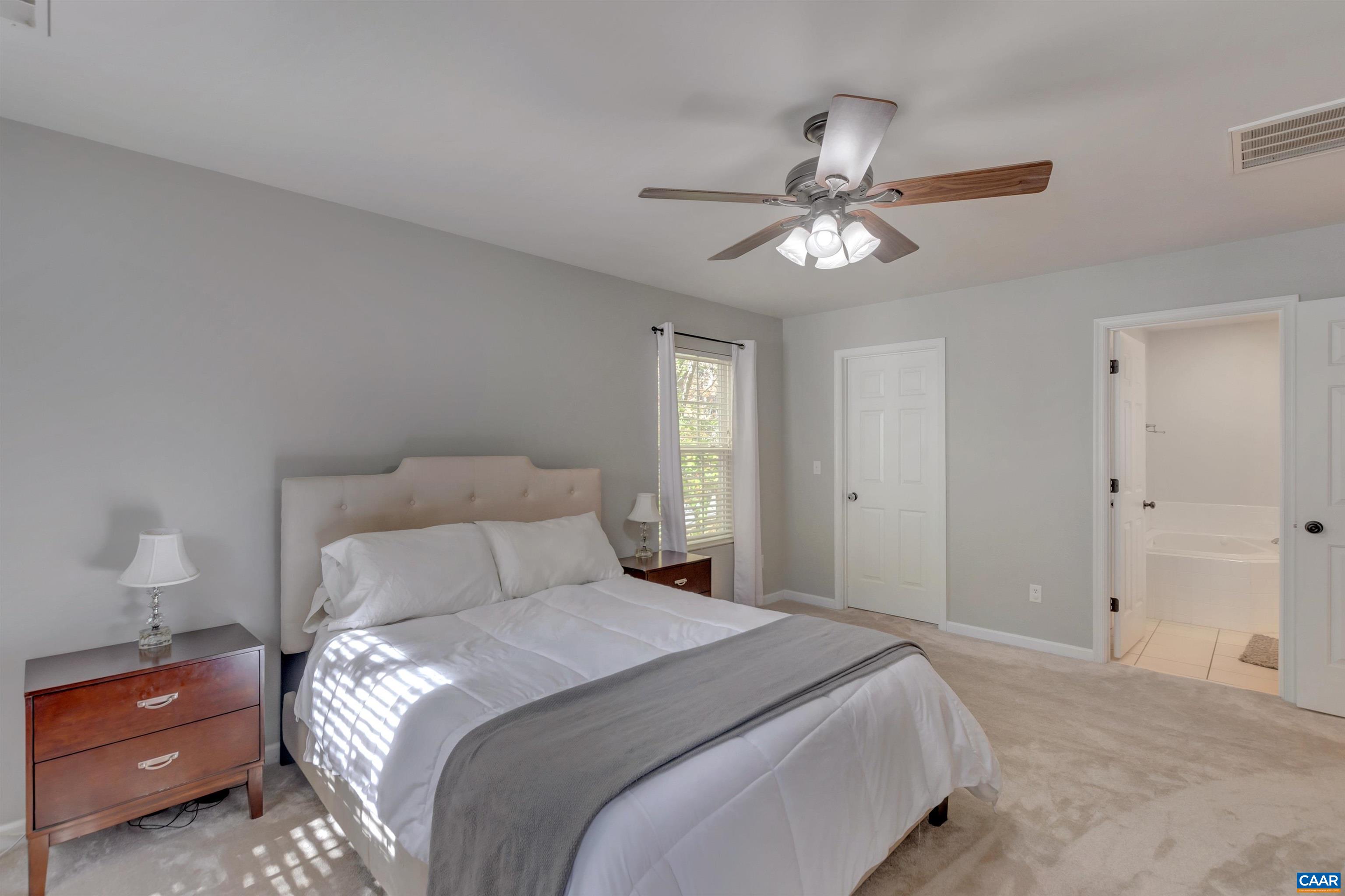27 East Point Road Palmyra, VA 22963 - Photo 41 of 62 a bedroom with a bed and a chandelier