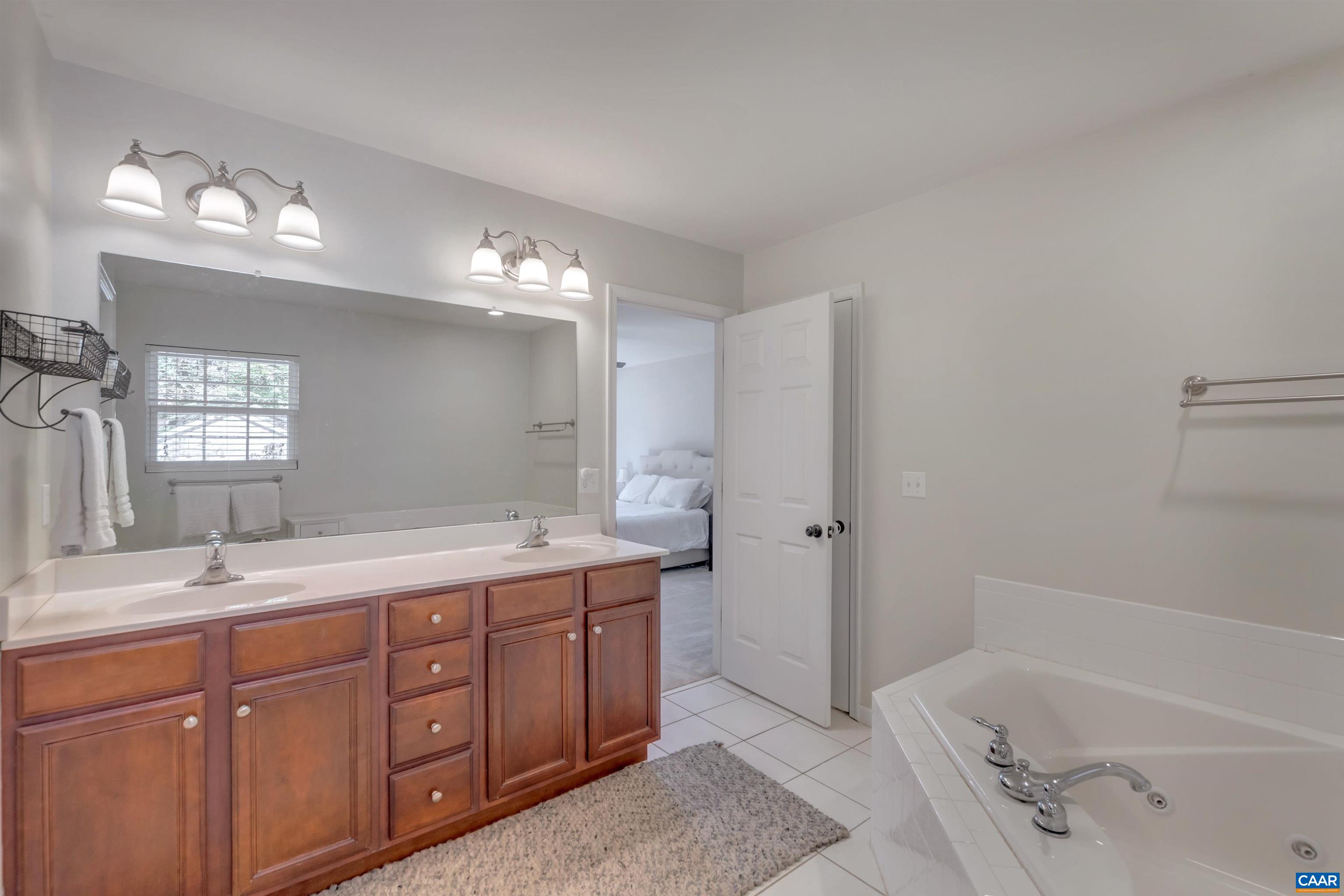 27 East Point Road Palmyra, VA 22963 - Photo 45 of 62 a bathroom with a tub sink double vanity and a mirror
