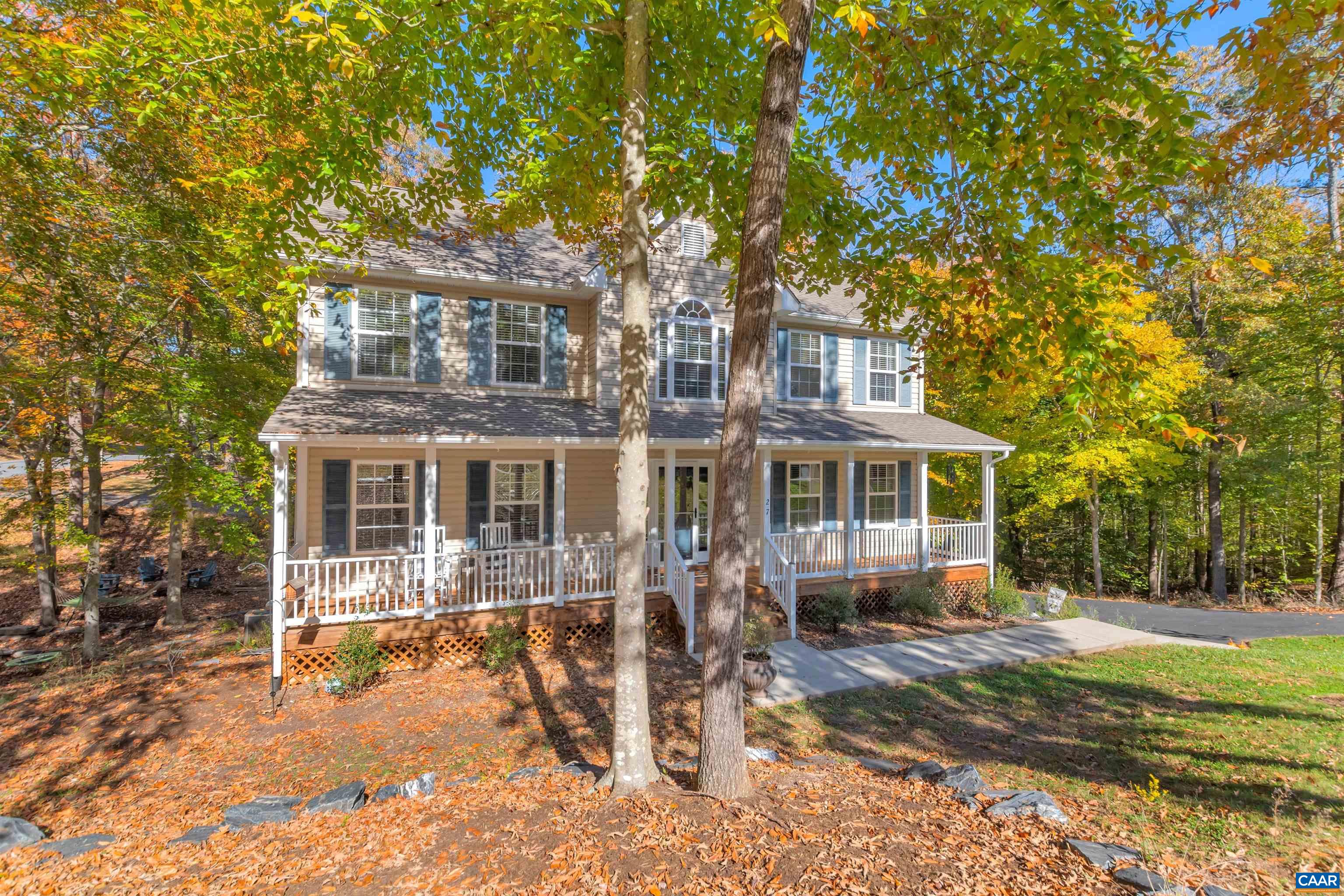 27 East Point Road Palmyra, VA 22963 - Photo 9 of 62 a front view of a house with a yard tree and wooden fence