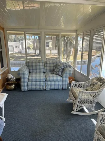 a bedroom with furniture and large windows