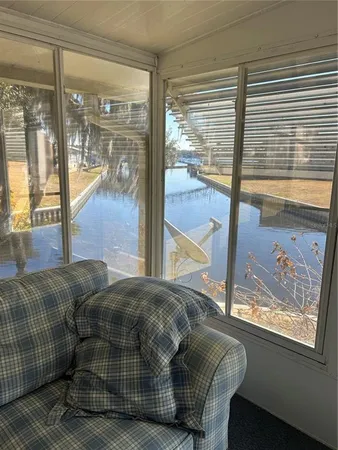 a living room with a bed and large windows