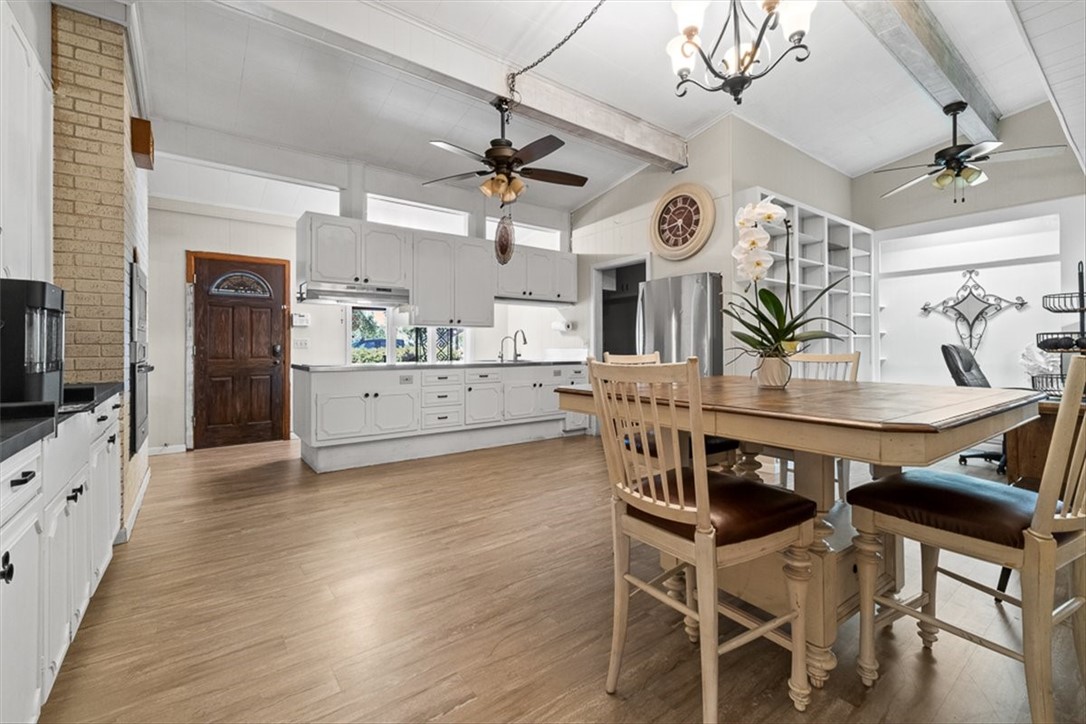 9675 County Road 325 Mathis, TX 78368 - Photo 18 of 29 a view of a dining room with furniture and wooden floor