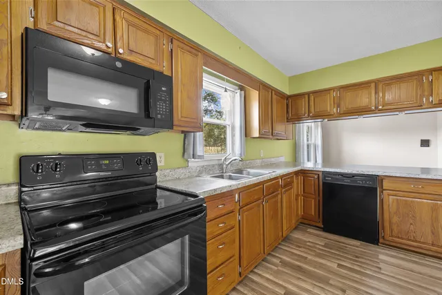 a kitchen with a stove microwave and sink