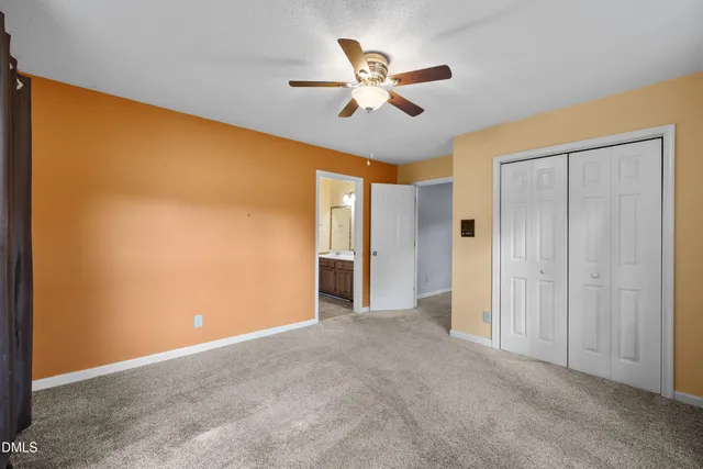 a view of an empty room with a ceiling fan
