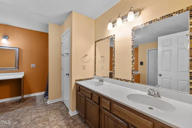 a bath room with a sink and a mirror