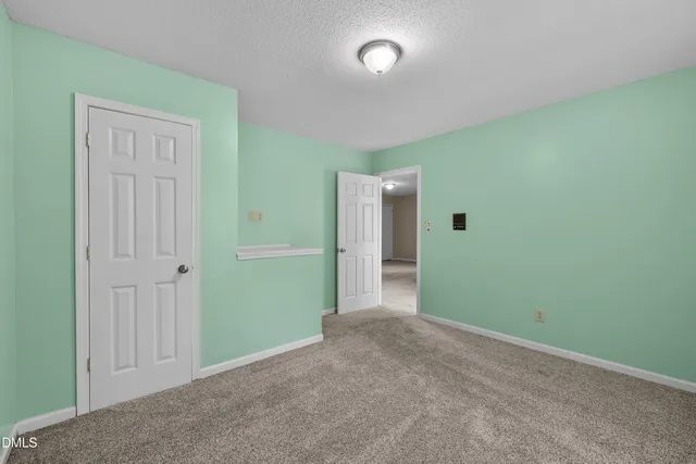 an empty room with closet area