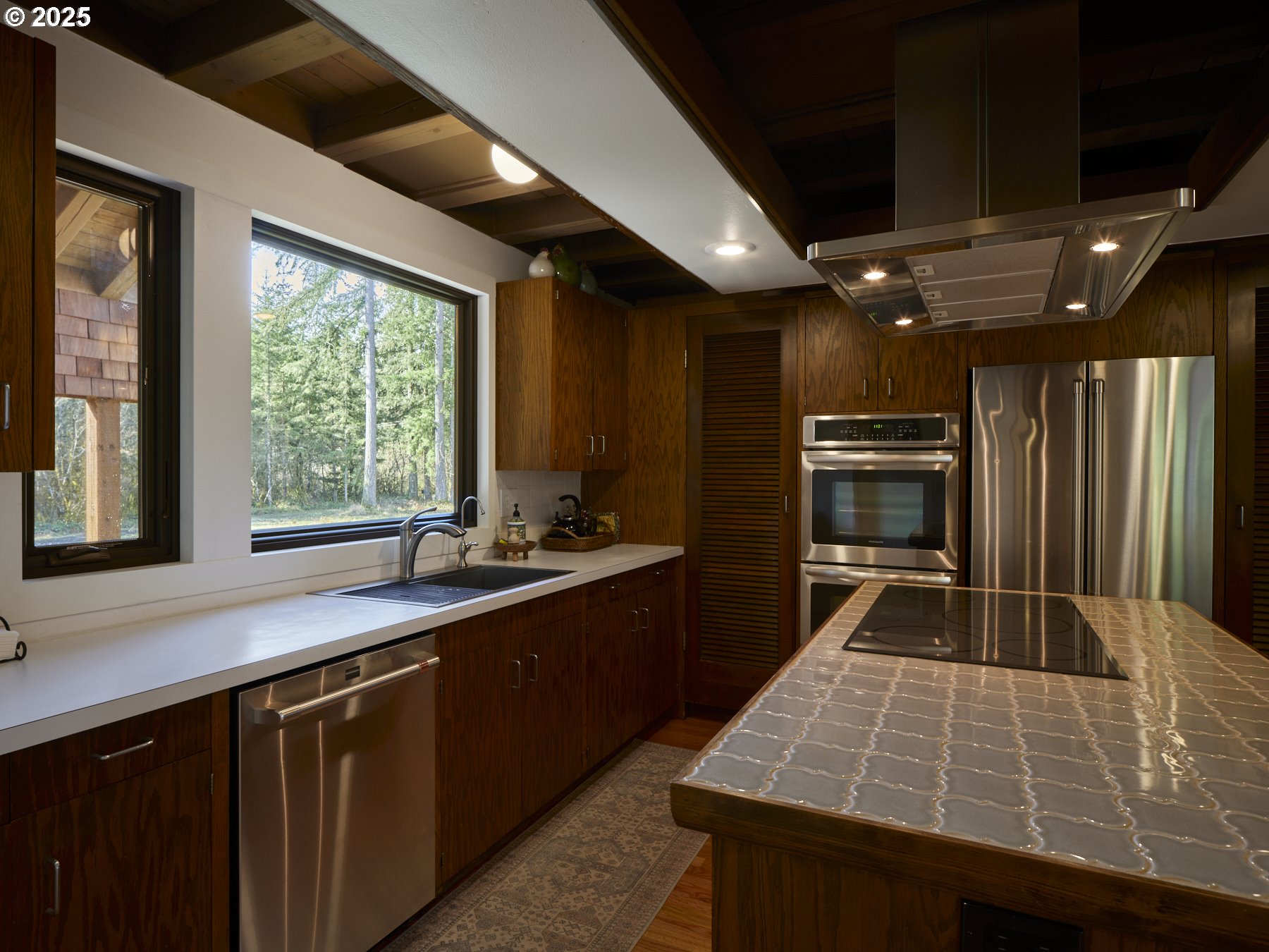 289 Classe Road Toledo, WA 98591 - Photo 13 of 48 a kitchen with kitchen island granite countertop a stove and a sink