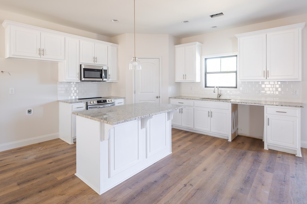 43 Lee Road Salem, AL 36874 - Photo 11 of 19 a kitchen with granite countertop a sink cabinets and wooden floor