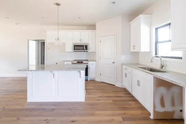 a view of kitchen with wooden floor