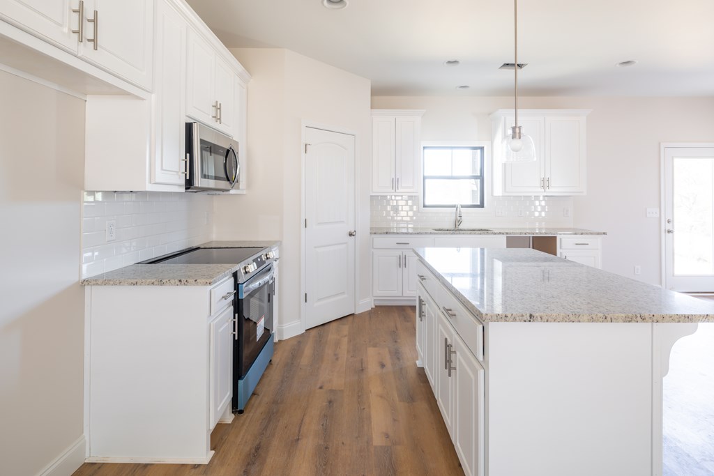 43 Lee Road Salem, AL 36874 - Photo 13 of 19 a kitchen with a sink a counter top space stainless steel appliances and a window