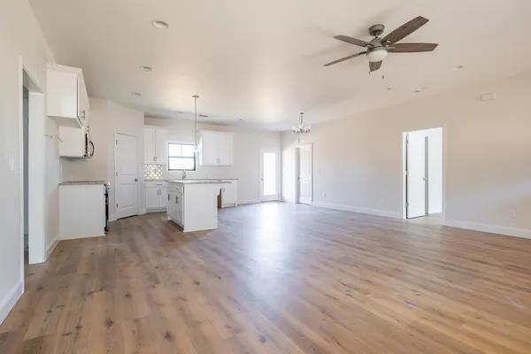 a view of a kitchen with a sink and a refrigerator