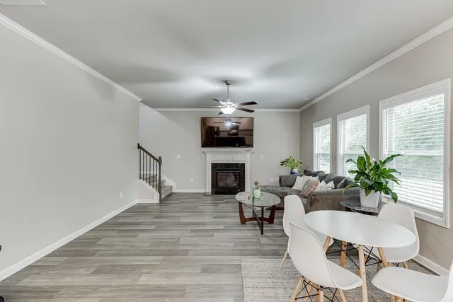 a living room with furniture and kitchen view