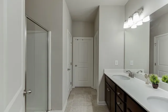 a bathroom with a sink double vanity and a mirror