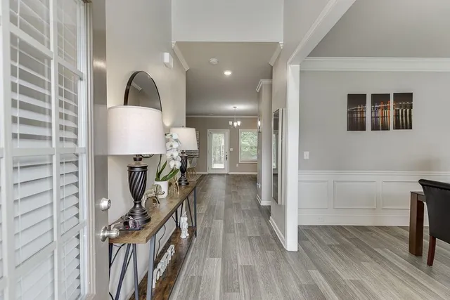 a view of a hallway with wooden floor and entryway