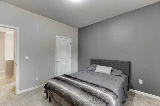 a bedroom with a bed and a a flat screen tv