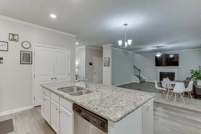 a kitchen with stainless steel appliances granite countertop a kitchen island a stove a cabinets and a sink