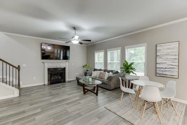 a living room with furniture a fireplace and a potted plant