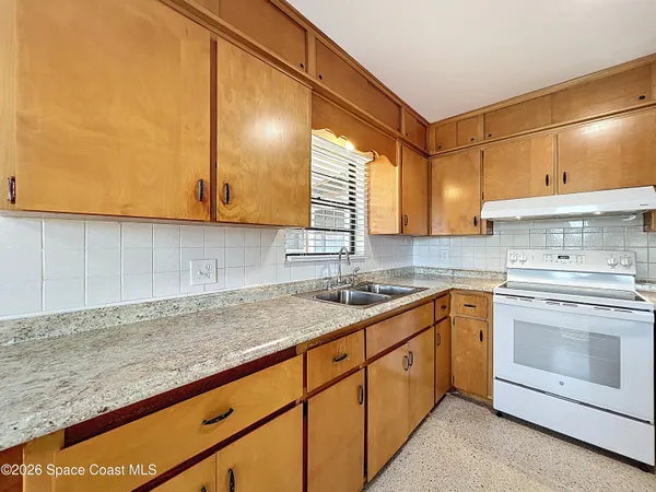 a kitchen with granite countertop cabinets stainless steel appliances and a sink