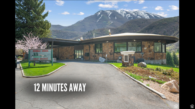 2042 South Valley Drive, Unit 57 Mapleton, UT 84664 - Photo 16 of 16 View of front facade featuring a mountain view, stone siding, and a front lawn