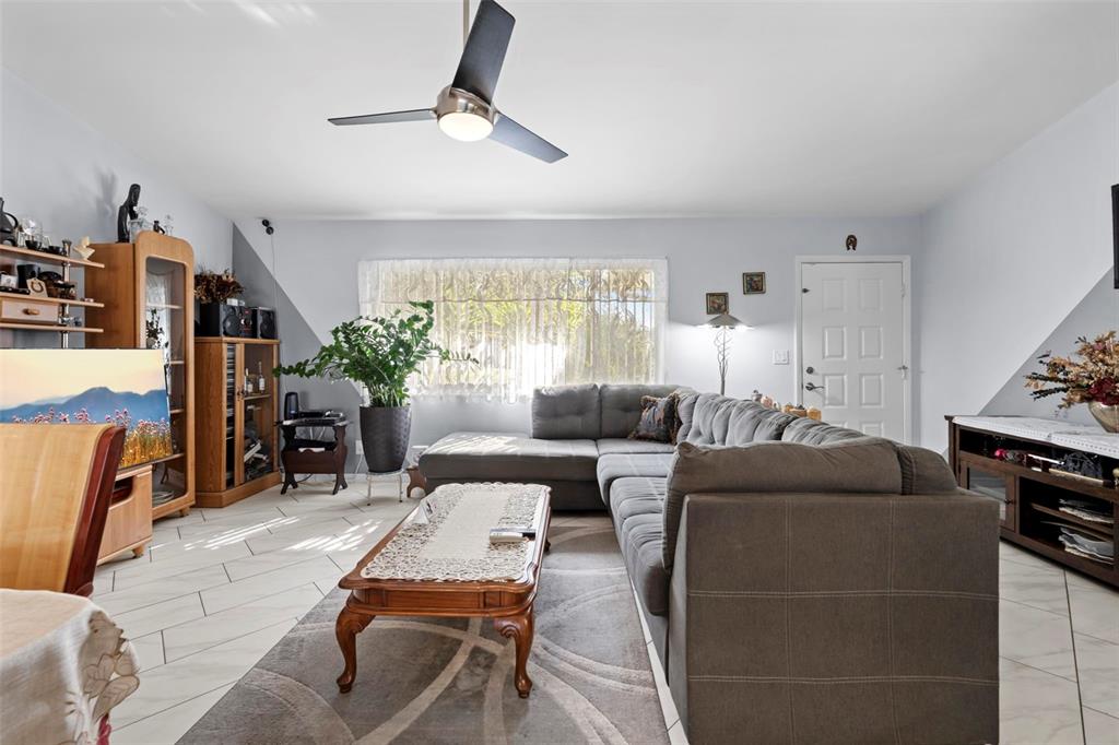 4307 Goldcoast Avenue Spring Hill, FL 34609 - Photo 16 of 53 a living room with furniture and a flat screen tv