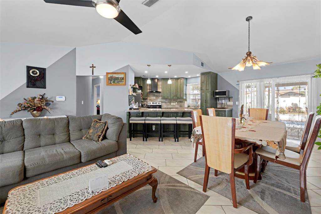 4307 Goldcoast Avenue Spring Hill, FL 34609 - Photo 18 of 53 a living room with furniture kitchen view and a chandelier
