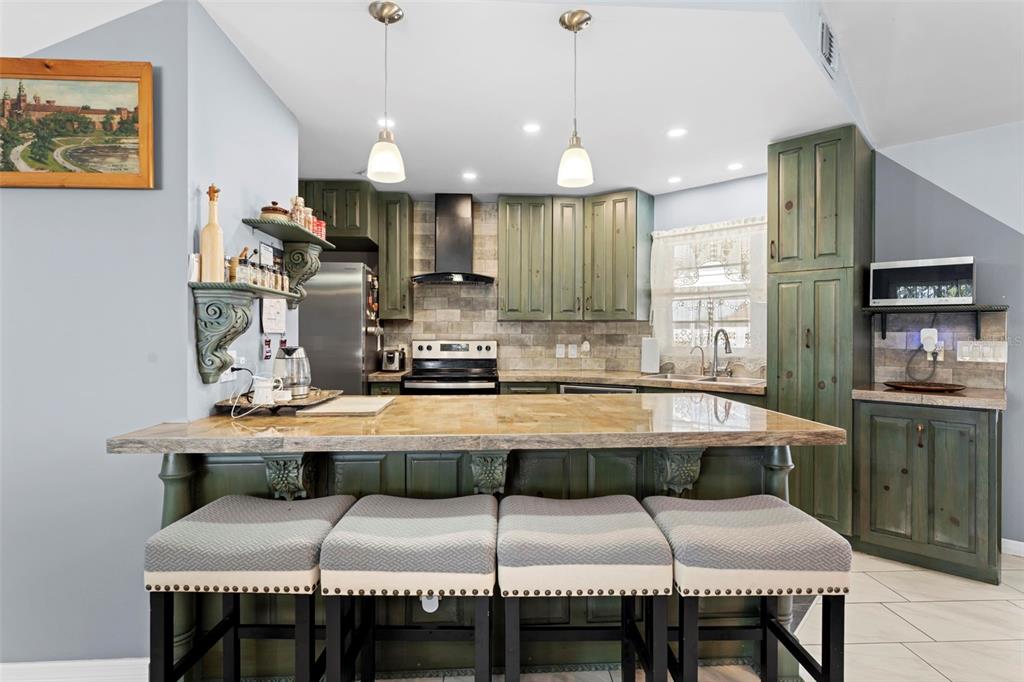 4307 Goldcoast Avenue Spring Hill, FL 34609 - Photo 20 of 53 a kitchen with a table chairs sink and cabinets