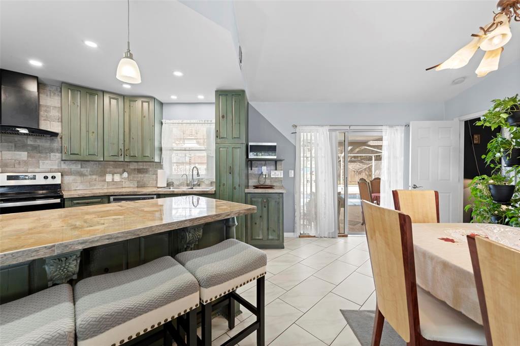 4307 Goldcoast Avenue Spring Hill, FL 34609 - Photo 21 of 53 a large kitchen with a table and chairs