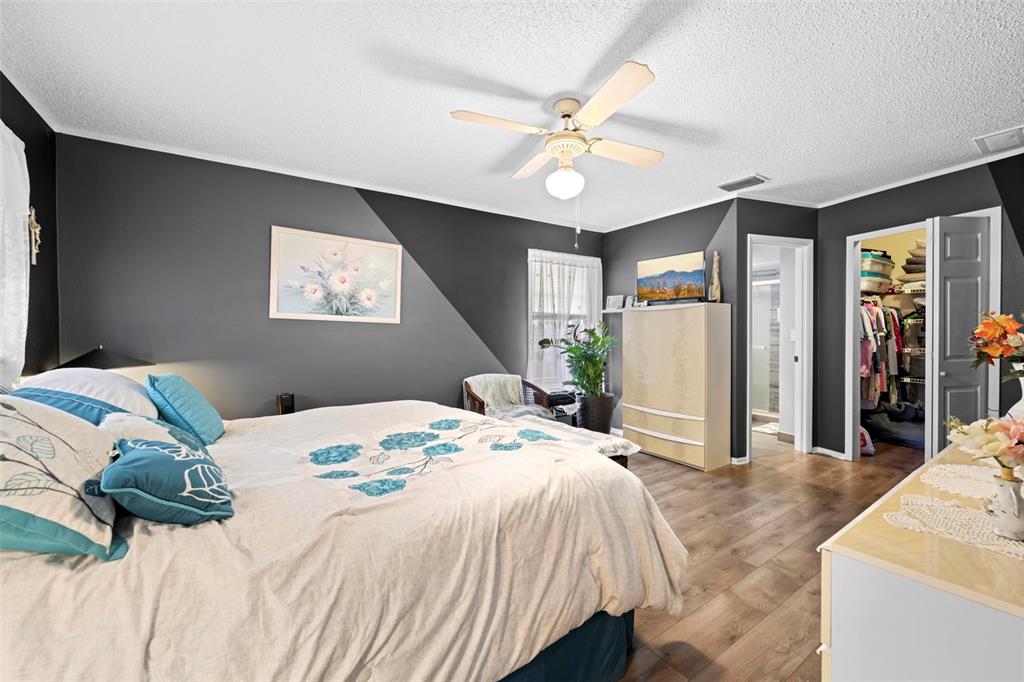 4307 Goldcoast Avenue Spring Hill, FL 34609 - Photo 27 of 53 a bedroom with a bed and a chandelier