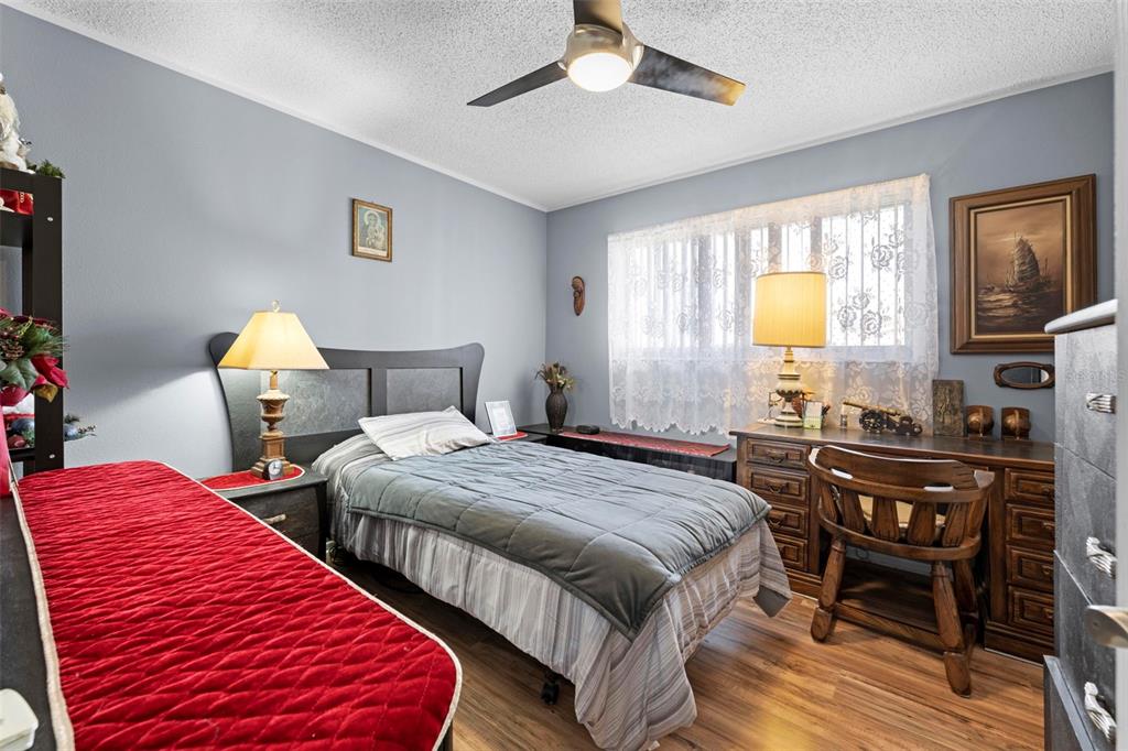 4307 Goldcoast Avenue Spring Hill, FL 34609 - Photo 32 of 53 a bedroom with two beds and a chandelier