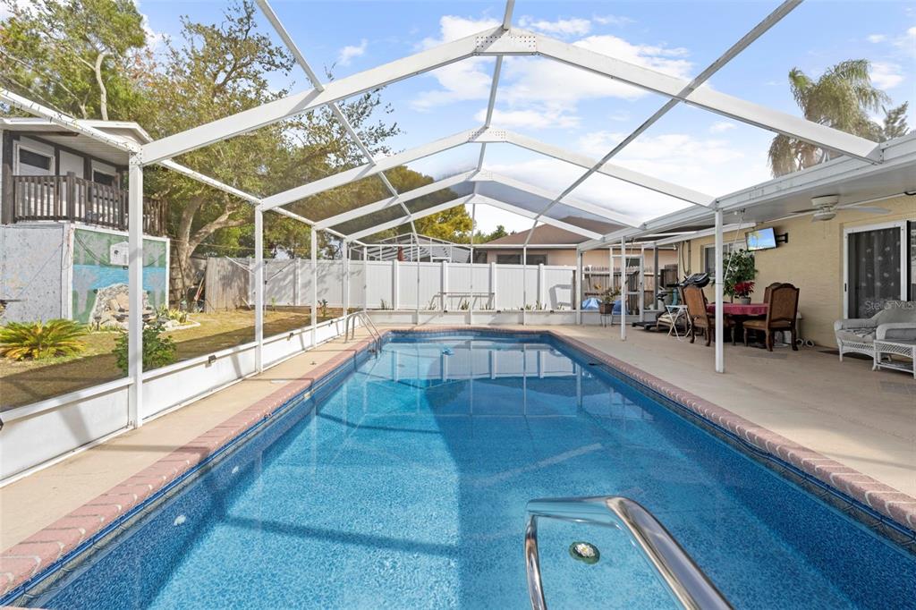4307 Goldcoast Avenue Spring Hill, FL 34609 - Photo 43 of 53 a view of a swimming pool with seating area