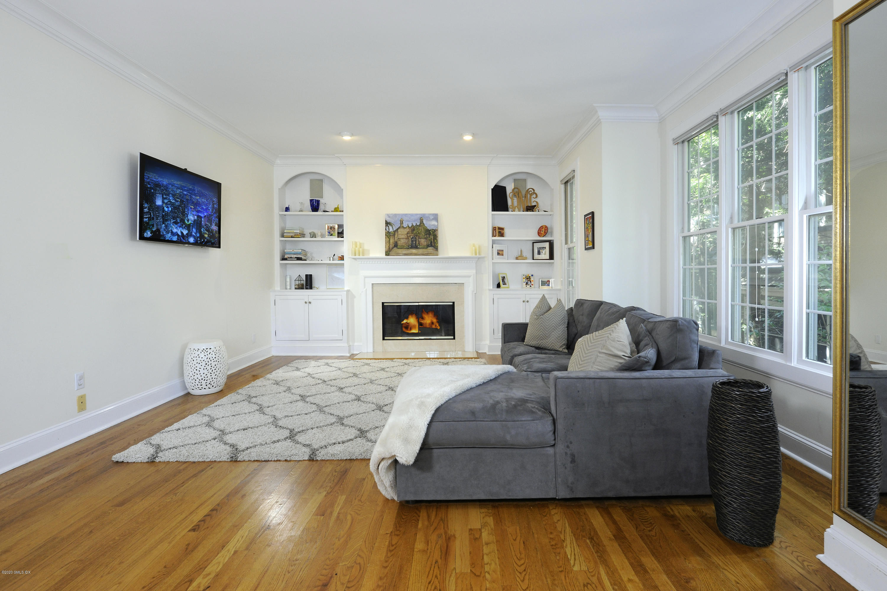 48 Spring Street, Unit 10 Greenwich, CT 06830 - Photo 3 of 11 a living room with furniture and a fireplace