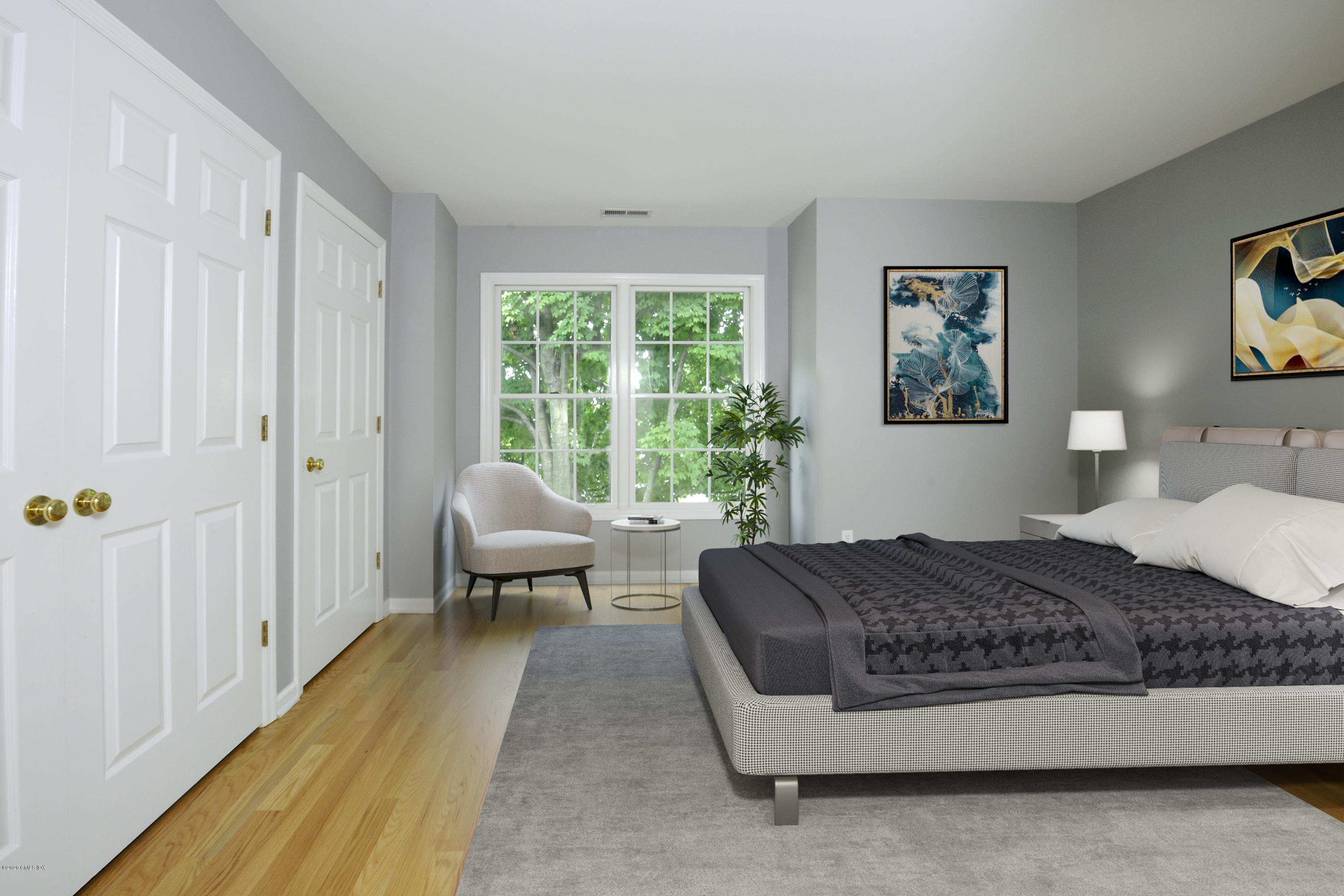 48 Spring Street, Unit 10 Greenwich, CT 06830 - Photo 9 of 11 a spacious bedroom with a bed a couch and a window