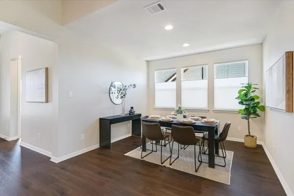 a view of a dining room with furniture window and wooden floor