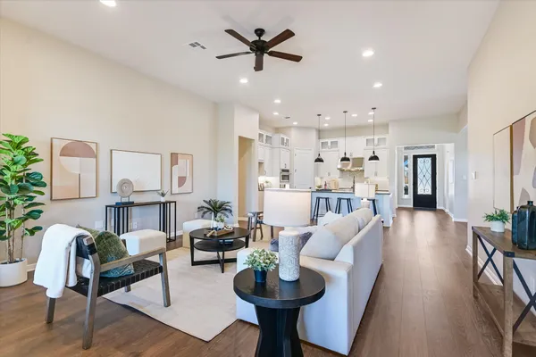 a living room with furniture a dining table and a potted plant