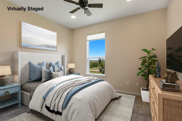 a bedroom with bed and a potted plant