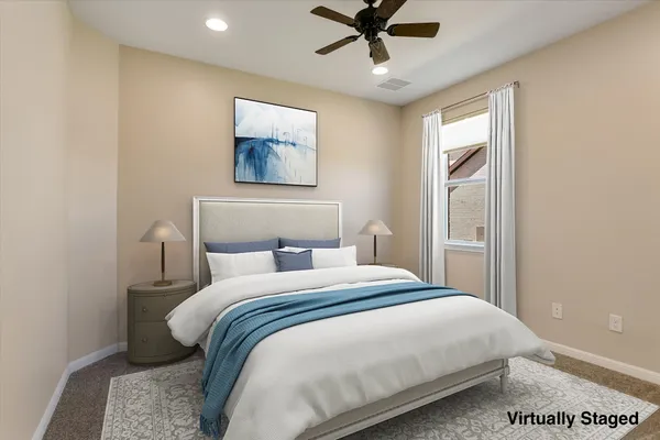 a bedroom with a large bed and a window