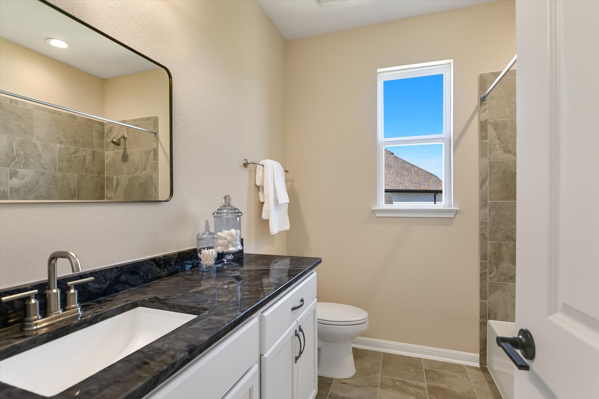 108 Trans Pecos Court Georgetown, TX 78628 - Photo 22 of 32 a bathroom with a granite countertop sink a toilet and a mirror