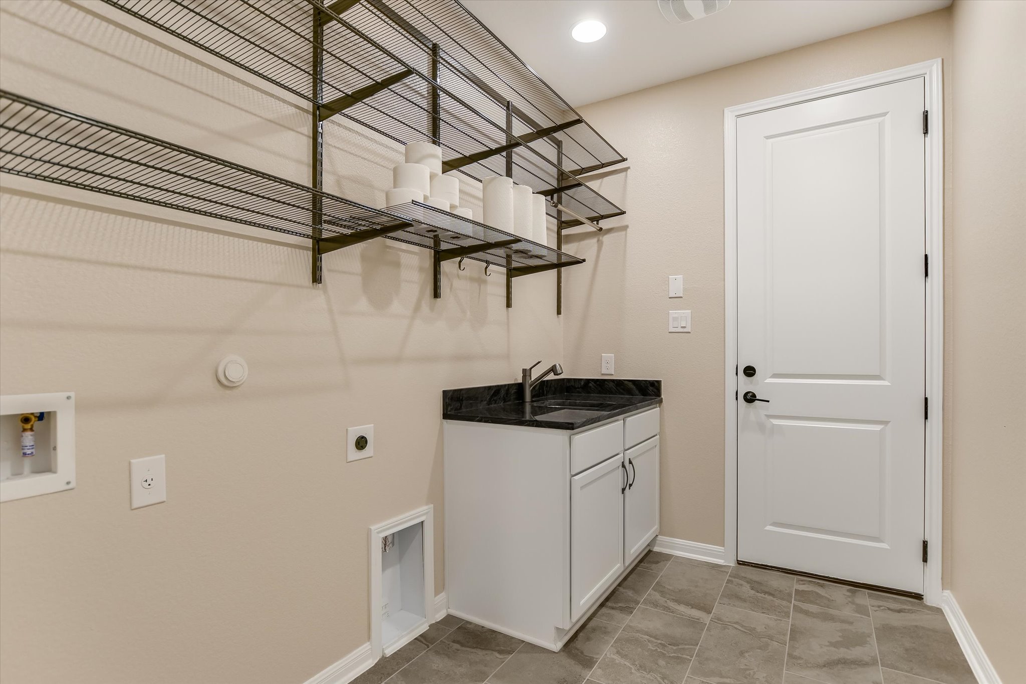 108 Trans Pecos Court Georgetown, TX 78628 - Photo 24 of 32 a kitchen with white cabinets and white appliances