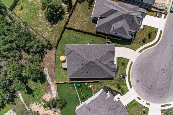 an aerial view of a house with a swimming pool