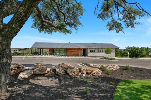 a view of a street with a building and trees in the background