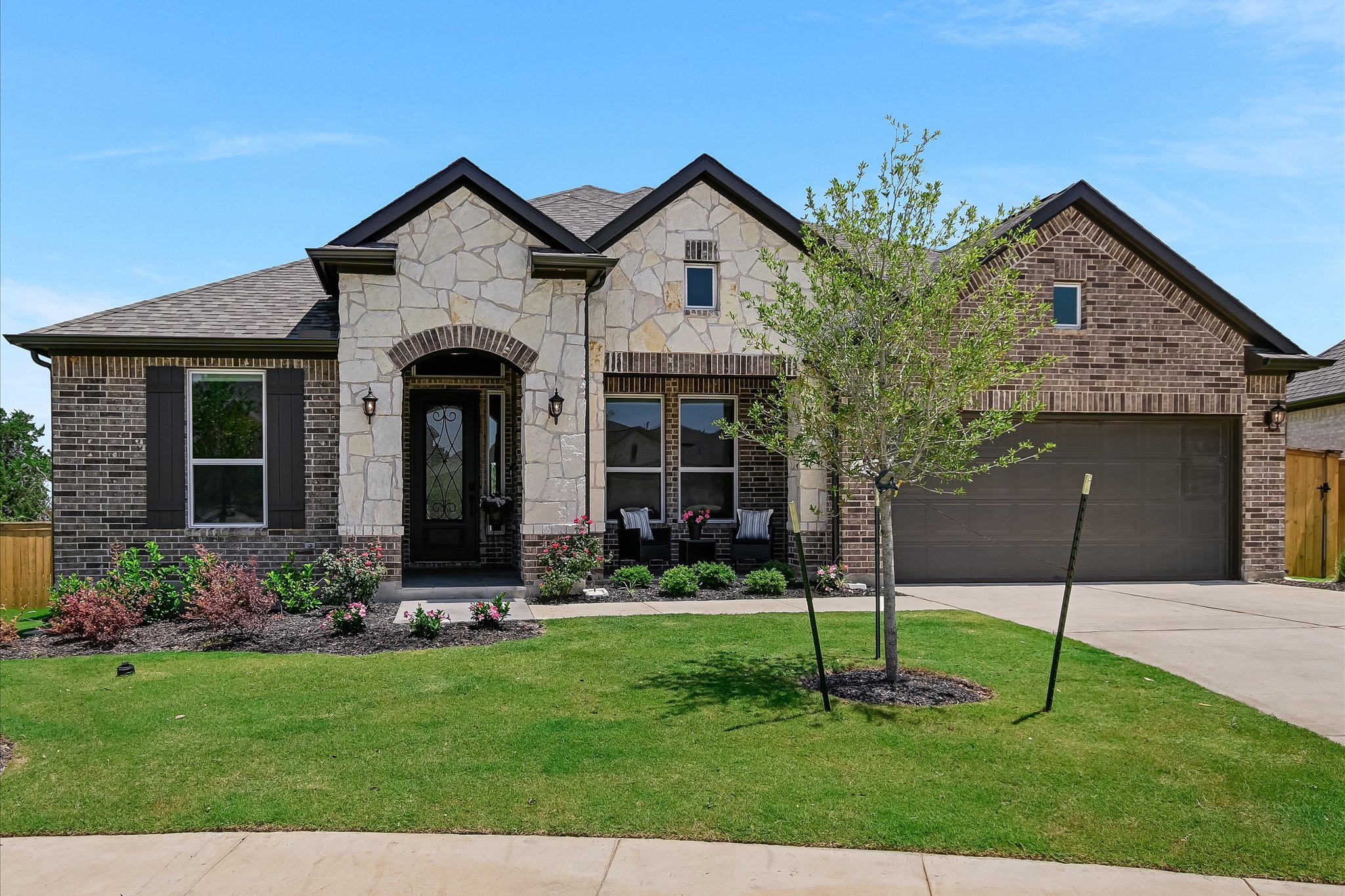 108 Trans Pecos Court Georgetown, TX 78628 - Photo 5 of 32 a front view of a house with a garden and plants