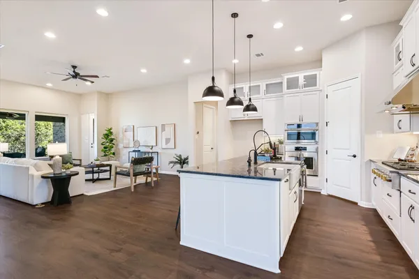 a kitchen with stainless steel appliances kitchen island a large island in the center