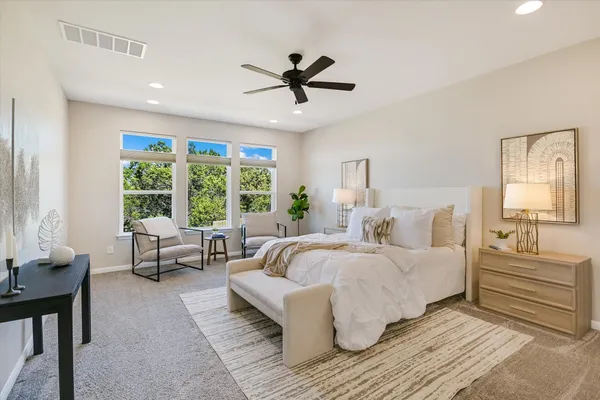a bedroom with a bed and a large window