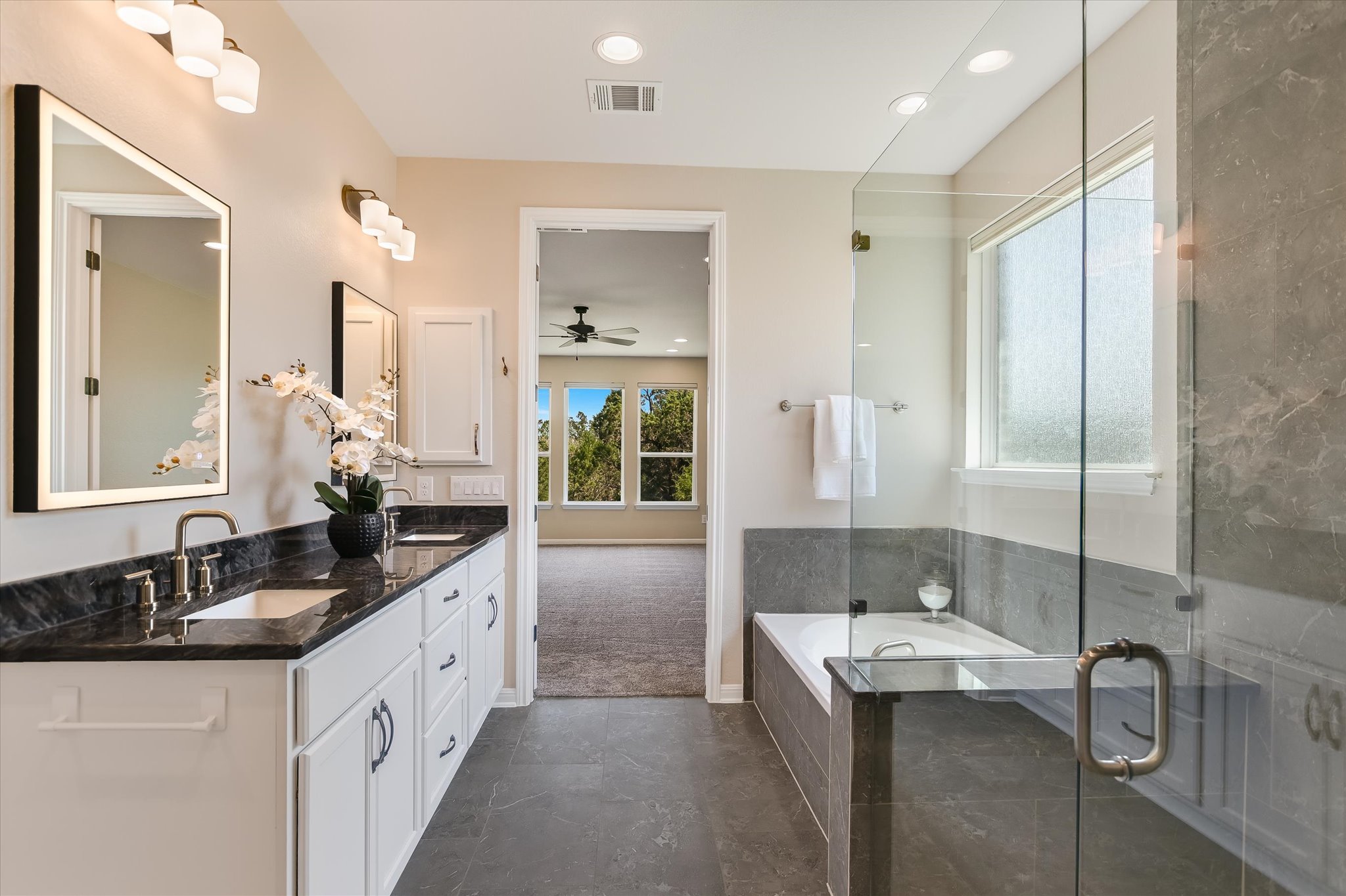 108 Trans Pecos Court Georgetown, TX 78628 - Photo 9 of 32 a spacious bathroom with a double vanity sink mirror and shower