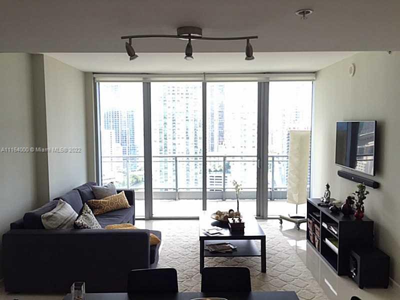 92 Southwest 3rd Street, Unit 2911 Miami, FL 33130 - Photo 1 of 16 a living room with furniture and a floor to ceiling window